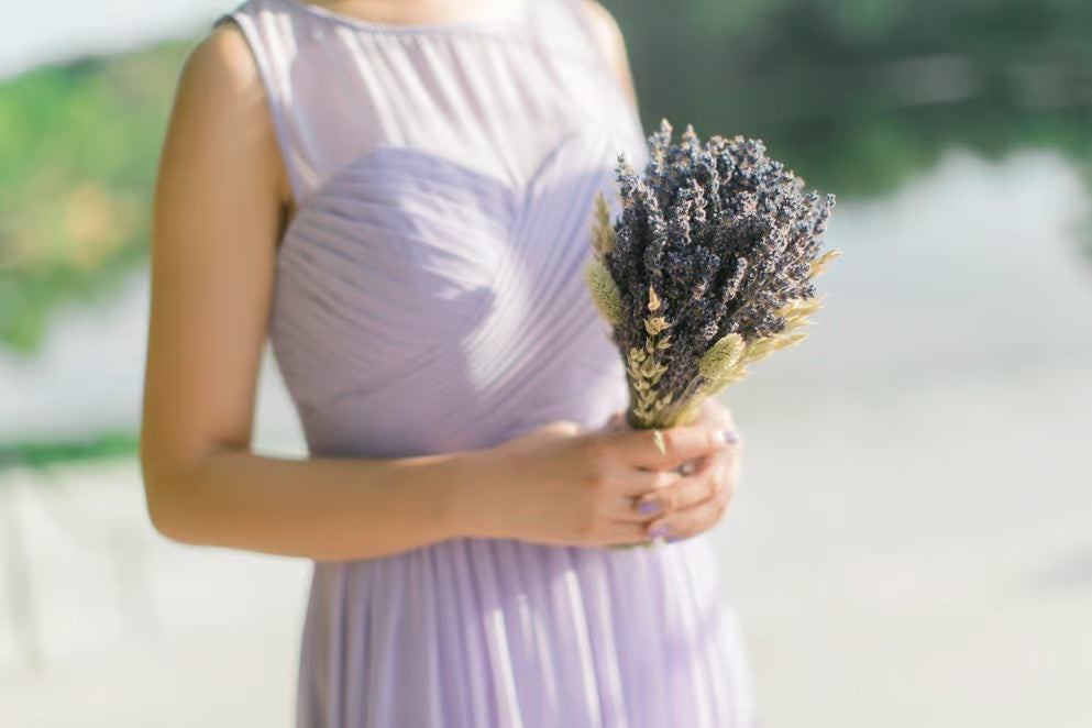 Maid of honor holding a bouquet of lavender.